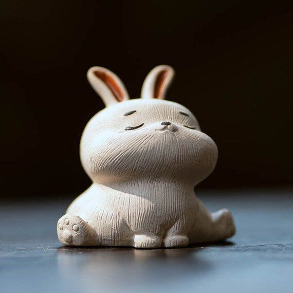 This is a Yixing purple clay rabbit teapet