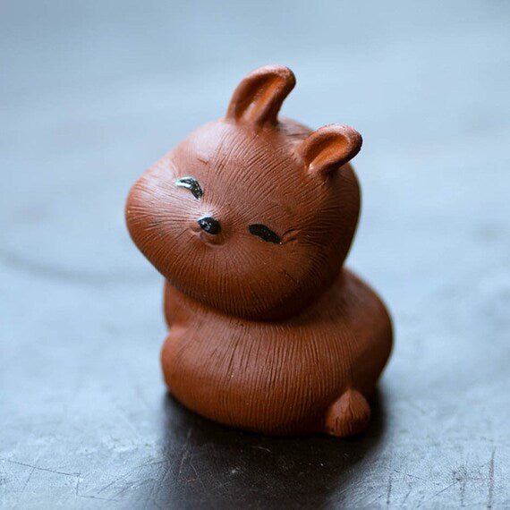 This is a Yixing purple clay rabbit teapet