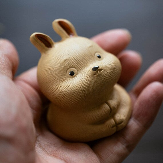 This is a Yixing purple clay rabbit teapet