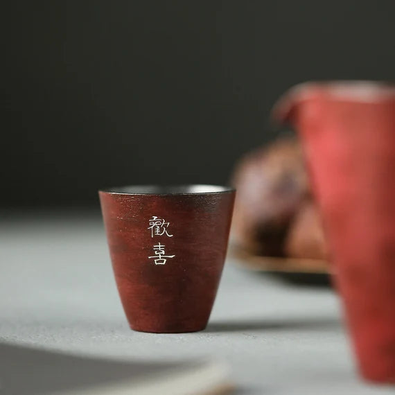 This is a pottery teacup.This is a gilted silver teacup