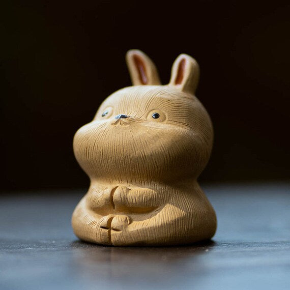 This is a Yixing purple clay rabbit teapet