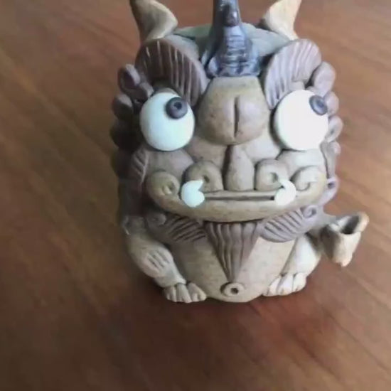 This is a pottery incense holder tea pet