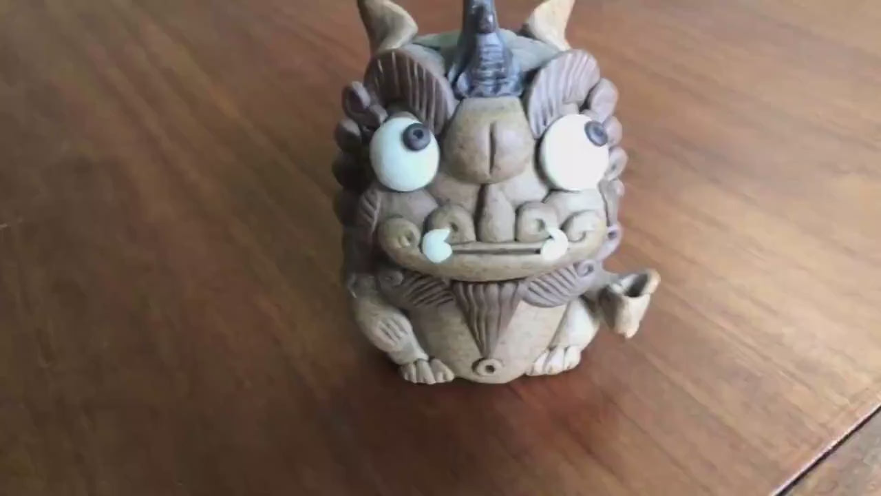 This is a pottery incense holder tea pet