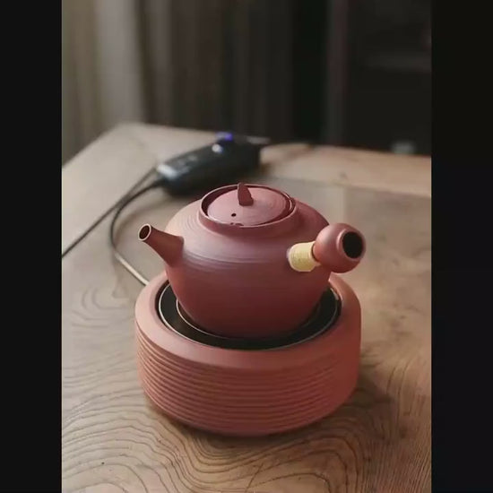 This is a pottery side handle kettle