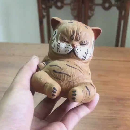 This is a Yixing purple clay tiger teapet