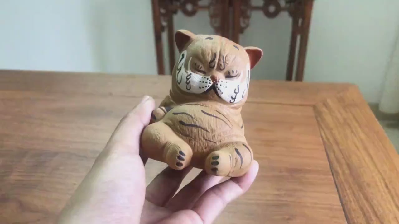 This is a Yixing purple clay tiger teapet