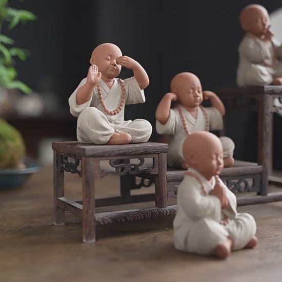 this is a mini pottery monk sculpture