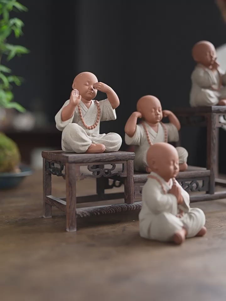 this is a mini pottery monk sculpture