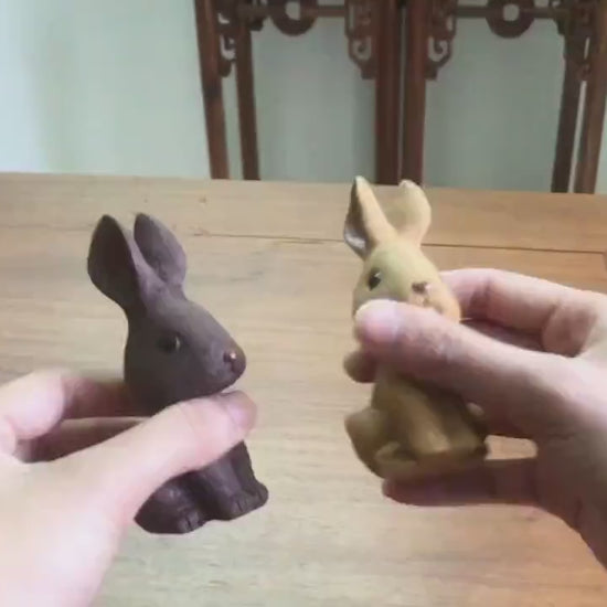 This is a Yixing purple clay rabbit teapet