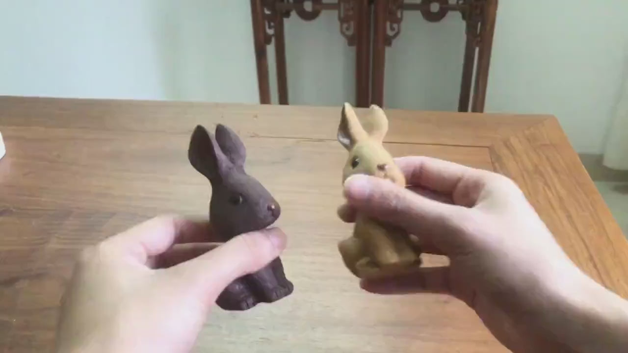 This is a Yixing purple clay rabbit teapet