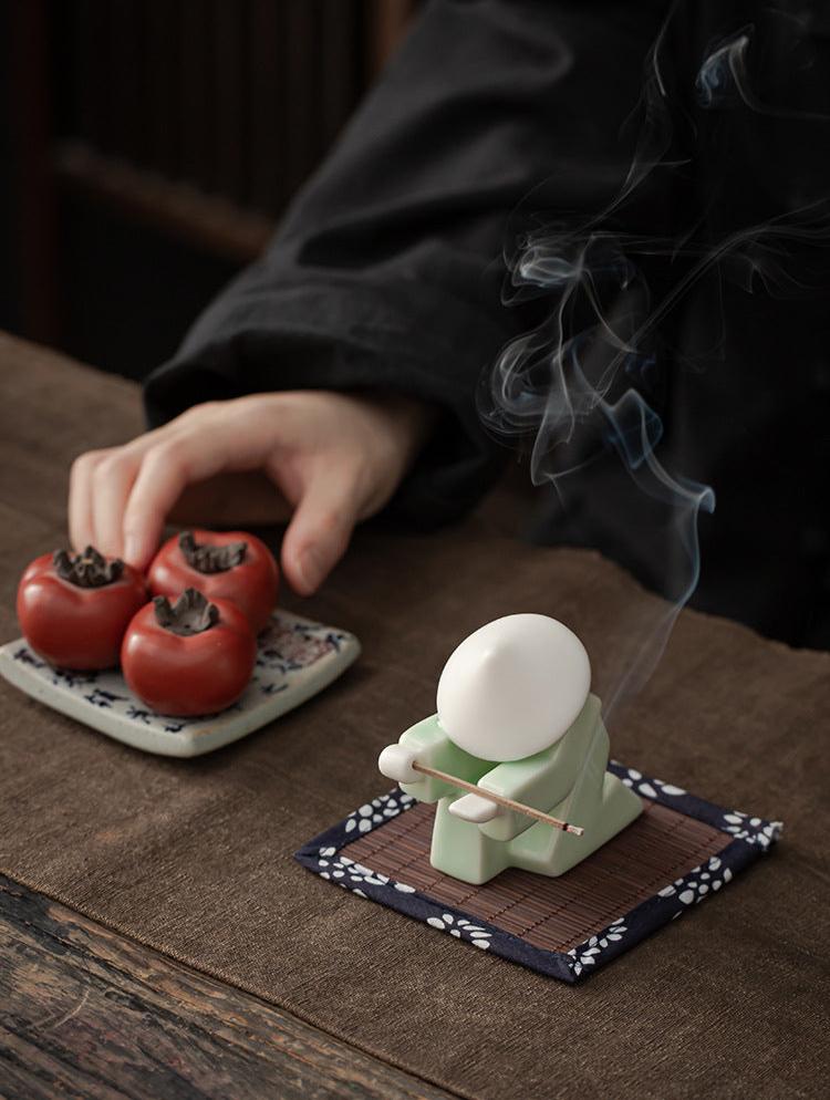 This is a ceramic incense holder tea pet