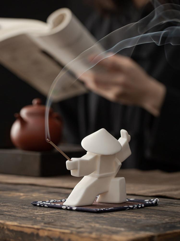 This is a ceramic incense holder tea pet