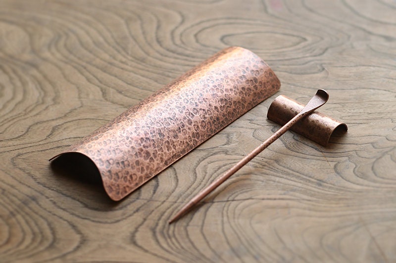 This is a copper tea scoop