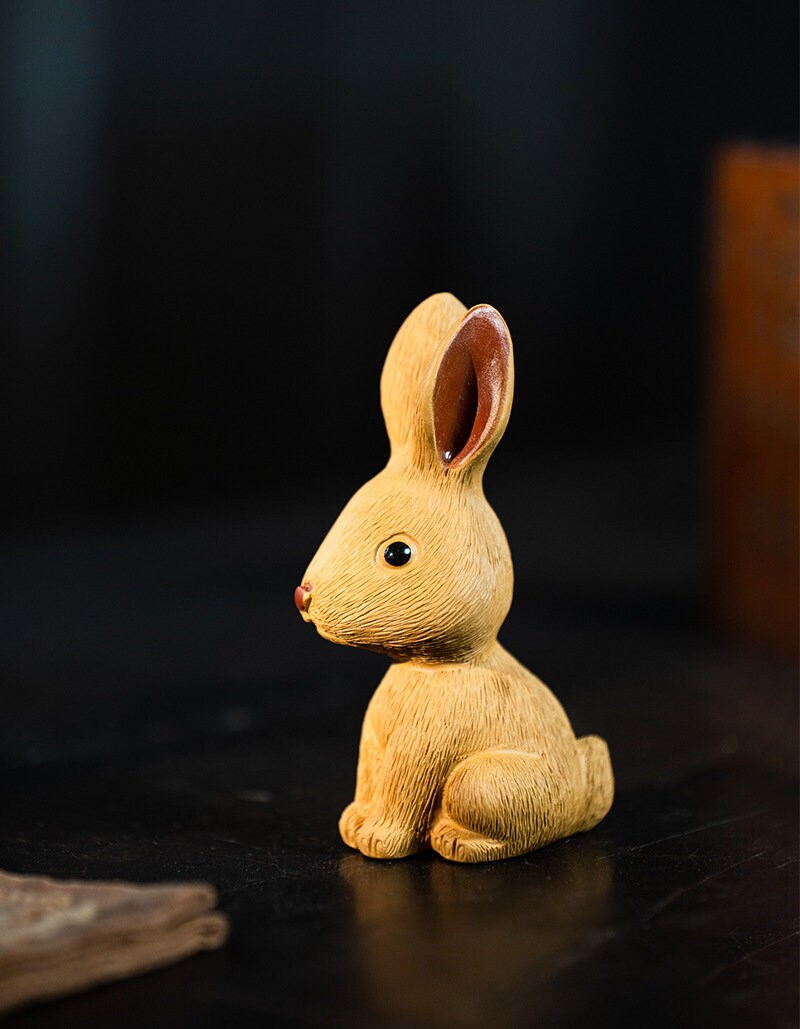 This is a Yixing purple clay rabbit teapet