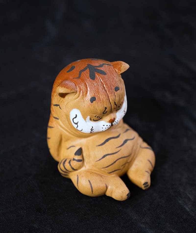 This is a Yixing purple clay tiger teapet