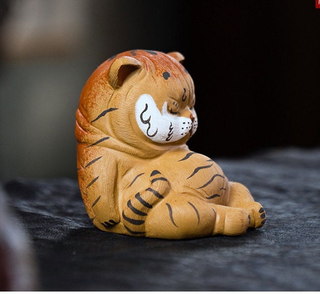 This is a Yixing purple clay tiger teapet