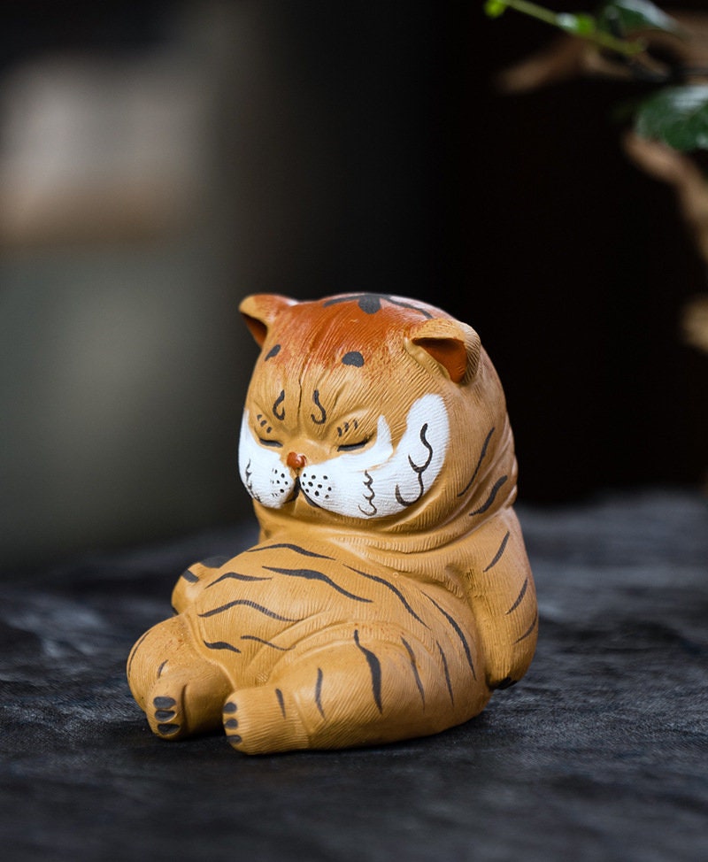 This is a Yixing purple clay tiger teapet