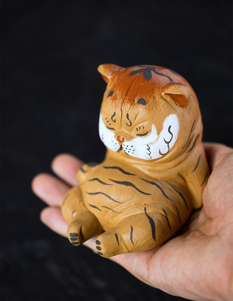 This is a Yixing purple clay tiger teapet