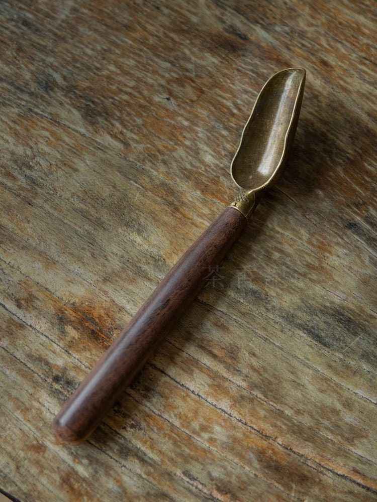 This is a wooden tea scoop