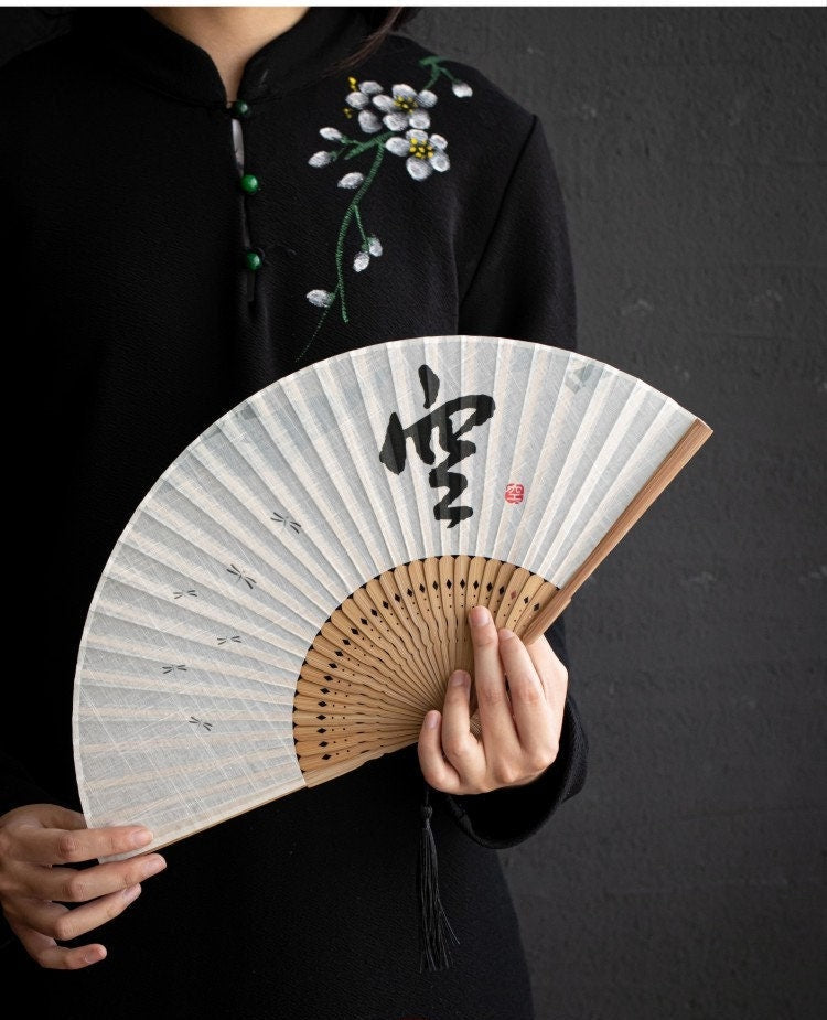 This is a bamboo cotton linen folding fan