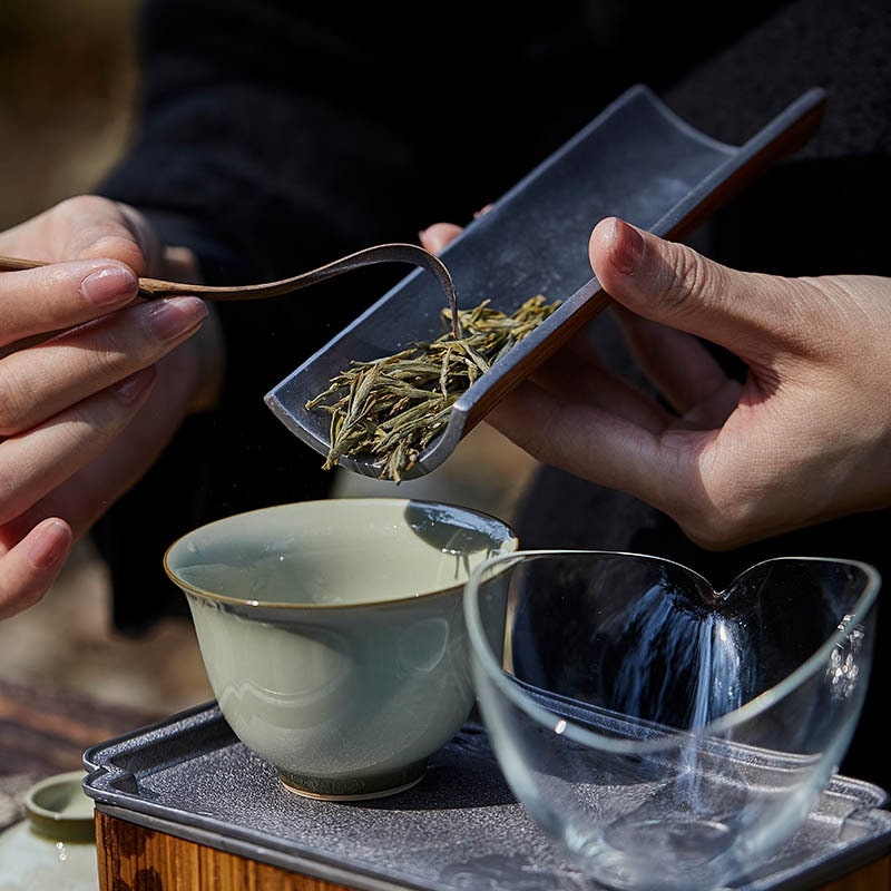 This is a tin bamboo tea scoop