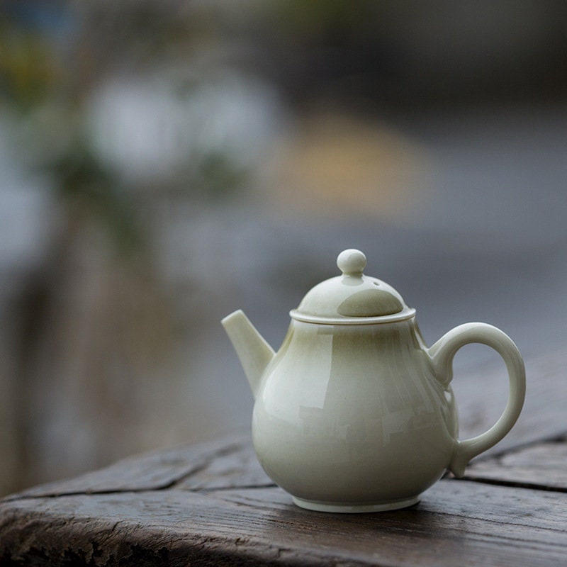 this is a wood ash glazed teapot.this is a ceramic teapot