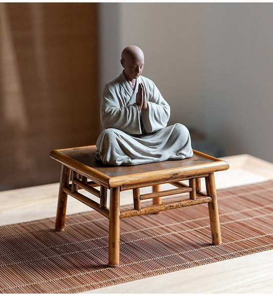 this is a mini pottery monk sculpture