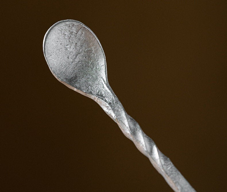 This is a tin tea scoop