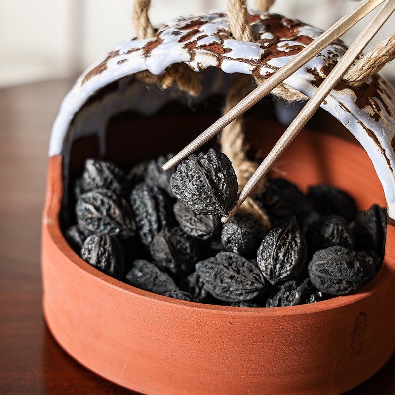 This is a pottery charcoal bowl